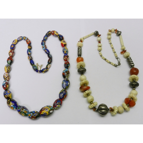 143 - Five bead necklaces incl a carnelian, bone and white metal example believed African, and a millefior... 