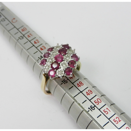 170 - A cluster ring comprising three lines of round cut synthetic pink stones spaced with two lines of il... 