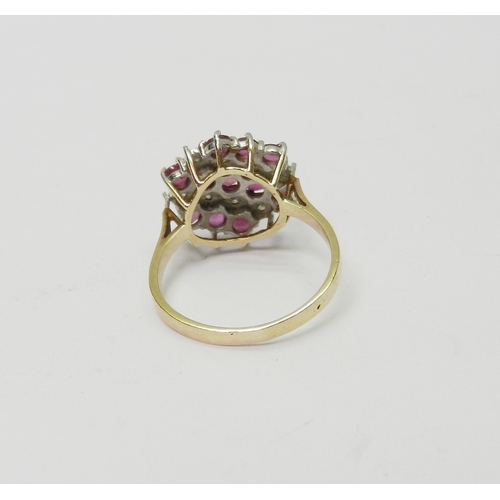 170 - A cluster ring comprising three lines of round cut synthetic pink stones spaced with two lines of il... 