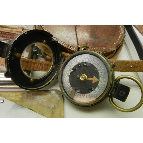 180 - A British Army marching compass dated 1917, cased; a three British army pocket knives, etc.