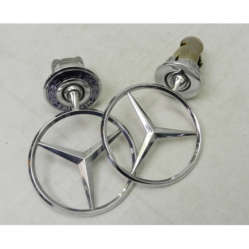 187 - Two Mercedes Benz radiator topper badges.