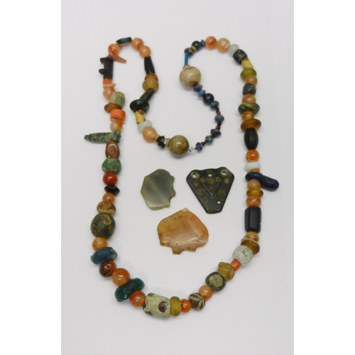 192 - Antiquarian interest: two strung bead necklaces including carnelian stones; a group of loose beads. ... 