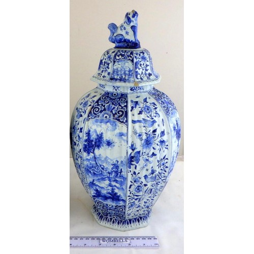 A pair of 19th century octagonal blue and white ribbed Delft lidded vases signed J . V 
38 CM tall,