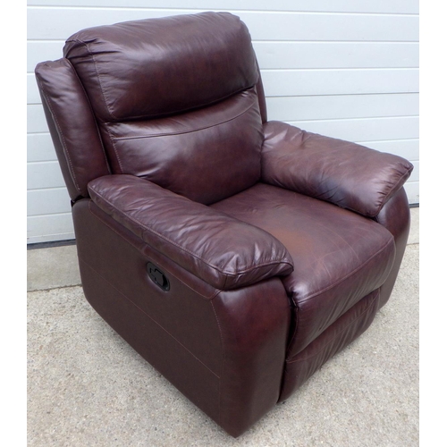 606 - A brown leather recliner chair, arm dented,