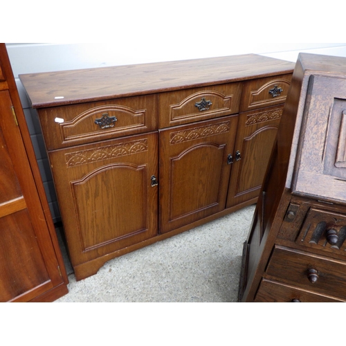 618 - A linenfold panelled oak bureau, a sideboard and a tallboy (3)