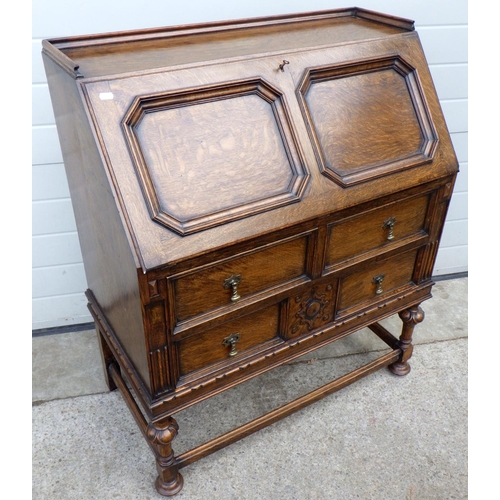 626 - A 1930's panelled oak bureau, 89cm wide