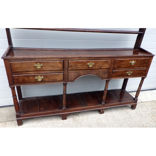 635 - An oak dresser with a rack & pot board, 190cm wide