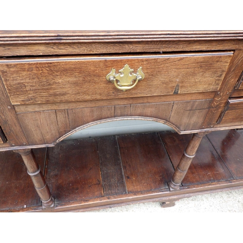 635 - An oak dresser with a rack & pot board, 190cm wide