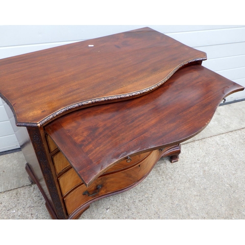 636 - A serpentine fronted mahogany chest of drawers with brushing slide on ogee bracket feet, 91cm wide