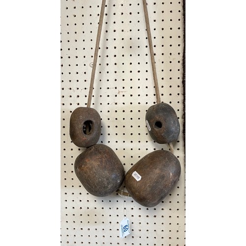 60 - Two heavy cast metal weights and two wooden on a rope ???