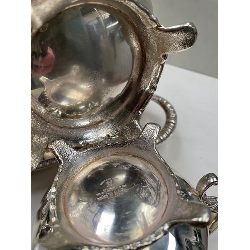 86 - A four piece silver plated tea set together with an oval tray