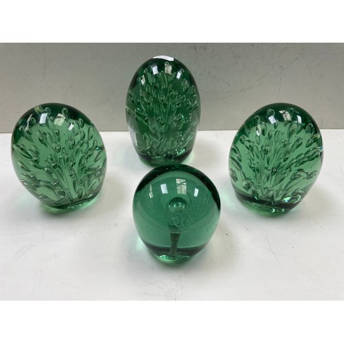 92 - A group of four Castleford type glass dumps / paperweights