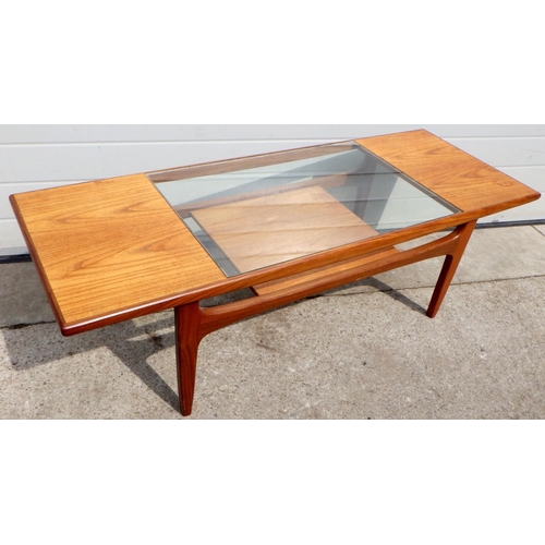 A teak coffee table with glass inset, 137cm long