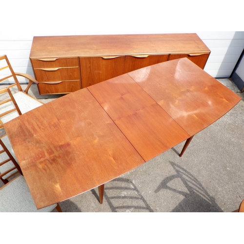 675 - A McIntosh teak extending dining table with one leaf & sideboard, together with six chairs, one with... 