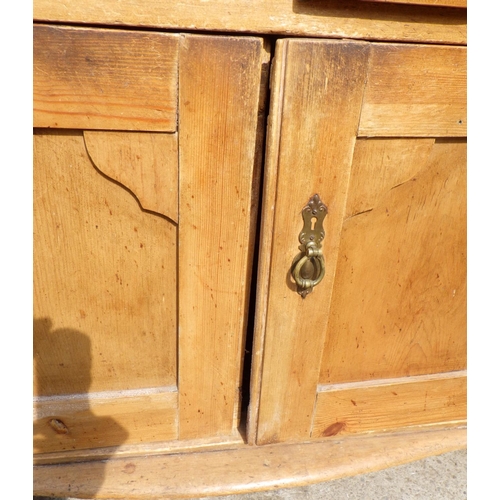 677 - A pine two door dresser with rack, 110cm wide, a/f
