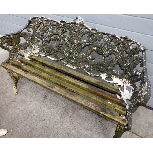 704 - A heavy cast iron garden bench together with two similar cast iron chairs (3)