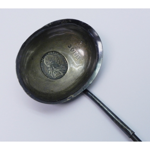 18 - A George III toddy ladle comprising a silver bowl inset with a George III 1787 shilling the whole on... 
