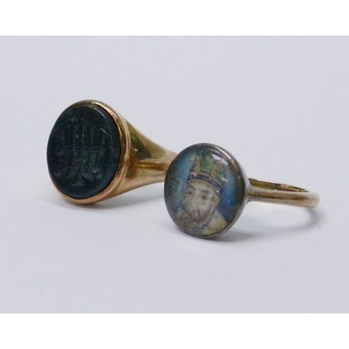 52 - A signet ring, unmarked yellow metal inset with a hardstone intaglio carved with an unidentified mon... 
