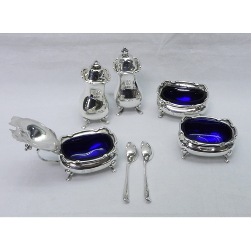 6 - A six piece silver condiment set having glass liners, feet a/f; a silver egg cup, a pair of silver c... 