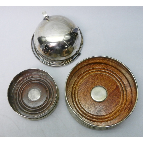 8 - Two silver and hardwood coasters, 20th cent, the larger 125mm across; a silver plated swing handled ... 