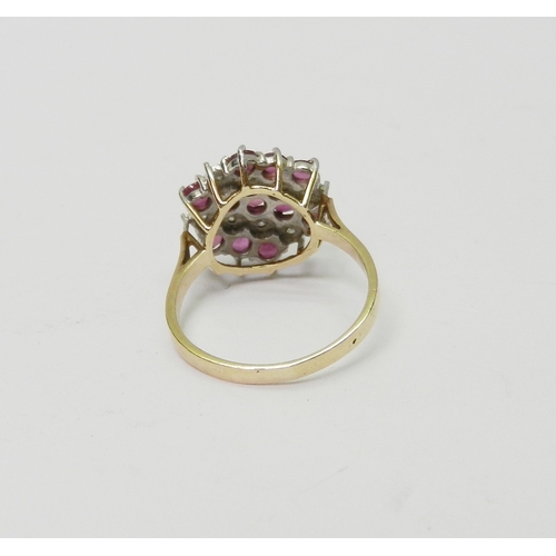 58 - A cluster ring comprising three lines of round cut synthetic pink stones spaced with two lines of il... 