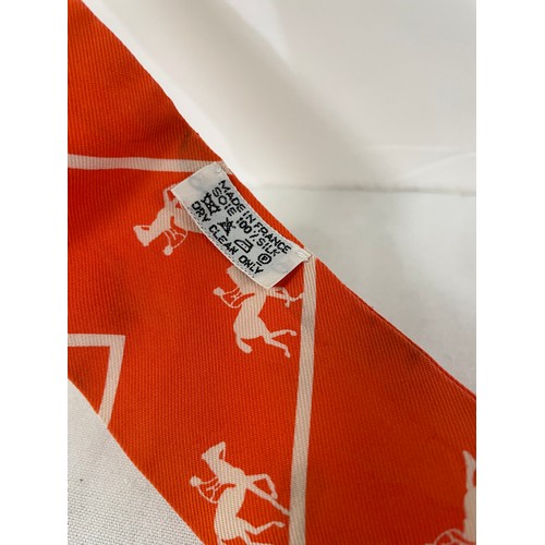 89 - A vintage Hermes Twilly scarf – “Duc Carriage Horses”, in the bold orange and cream colourway with o... 