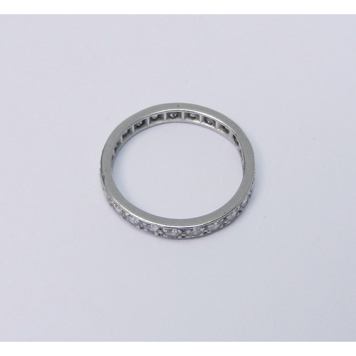 102 - A full hoop eternity ring, unmarked white metal and diamonds.  A/F slight distortion.  Size N 1/2