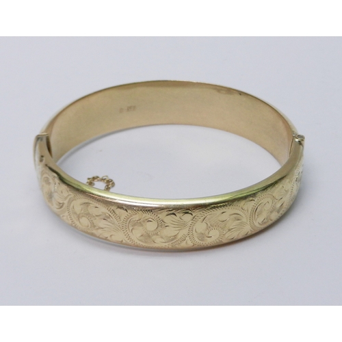 107 - A hinge bangle, 9ct gold late 20th cent.  A/F dented.  59mm interior diameter at hinge / 17g