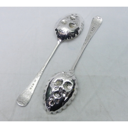 27 - A cased pair of silver berry spoons each 179mm long, other silver cutlery together with a silver mat... 