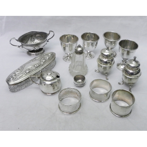 28 - Silver incl four various eggs cups, three single napkins rings, a boat-shaped pedestal salt, a pair ... 