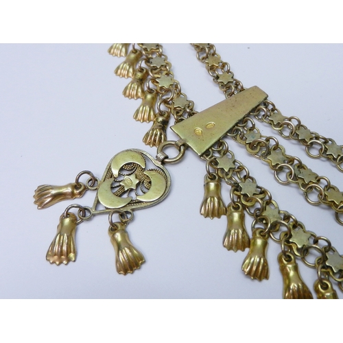 63 - A Middle Eastern triple chain fringe necklace, yellow metal indistinctly marked.  480mm long / 65mm ... 