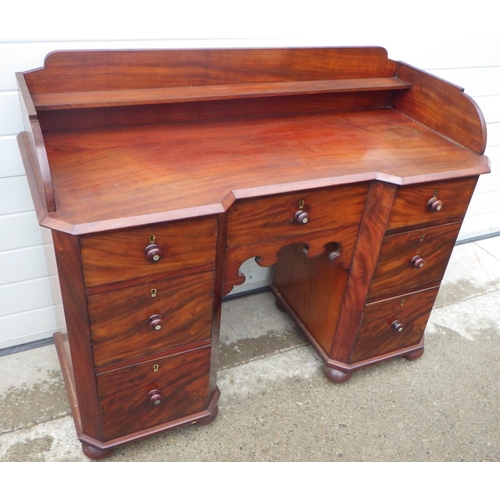 887 - A Victorian mahogany kneehole dressing table, missing some back boards, 127cm wide