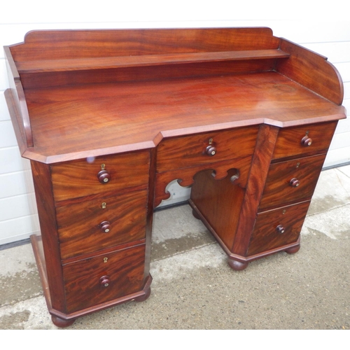 887 - A Victorian mahogany kneehole dressing table, missing some back boards, 127cm wide