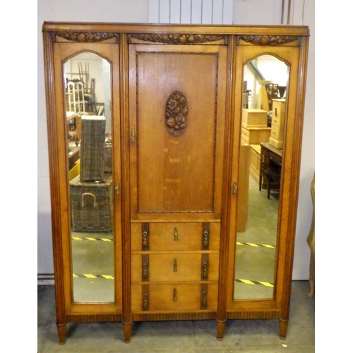 900 - An oak wardrobe with mirrored doors, 148cm wide