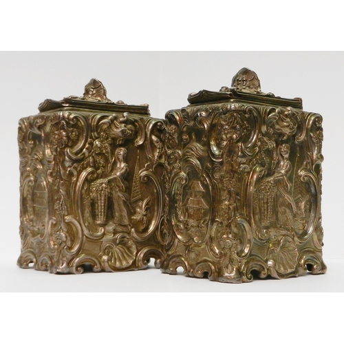 16 - A pair of early George III silver repousse canisters having Chinoiserie panels within a Rococo groun...