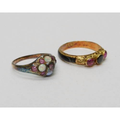 A trilogy ring, yellow metal marked 22k set with three cabochons with a black panel inset to the shank, size K; a cluster ring set with opals and pink sapphires, unmarked yellow metal, size H.  (2)