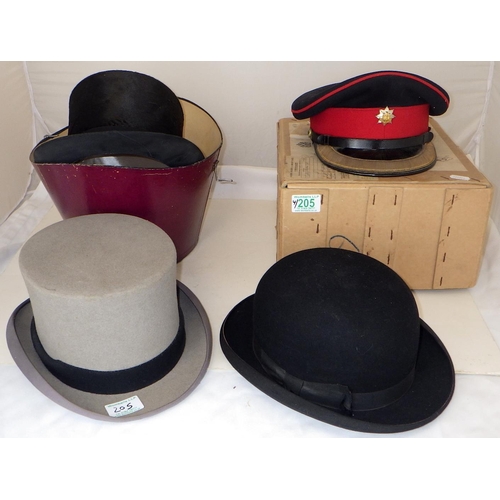 205 - A Royal Anglian officer's dress cap together with two top hats and a bowlers hat (4)