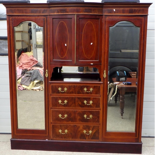 733 - An Edwardian mahogany and satinwood banded triple wardrobe with exposed drawers,