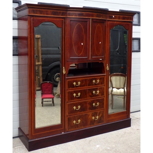 733 - An Edwardian mahogany and satinwood banded triple wardrobe with exposed drawers,