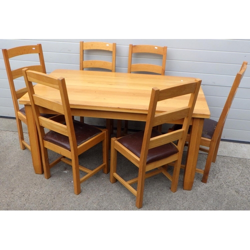 735 - A modern oak dining table, 150cm long, with six ladderback chairs (7)