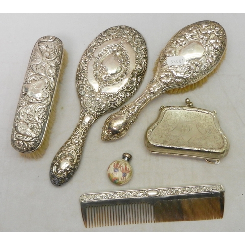 12 - A matched silver brush set comprising mirror, two brushes and a comb; a silver plated evening purse;... 