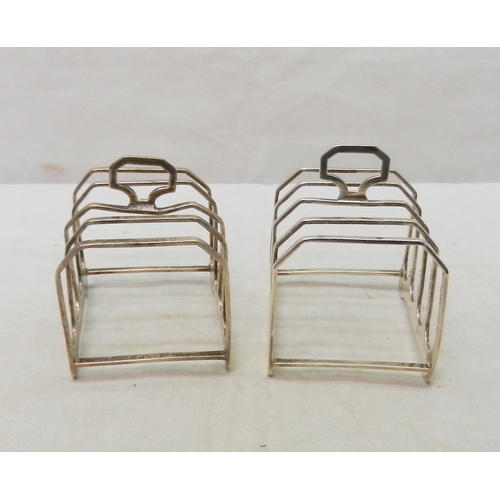 18 - A matching silver jug and two-handled sugar basin; a pair of silver toast racks.  Jug 85mm long incl... 