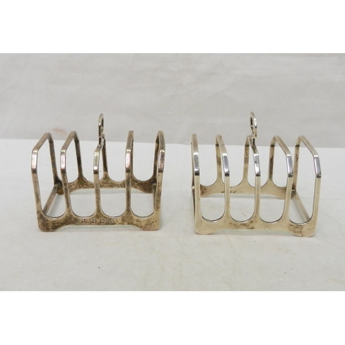 18 - A matching silver jug and two-handled sugar basin; a pair of silver toast racks.  Jug 85mm long incl... 