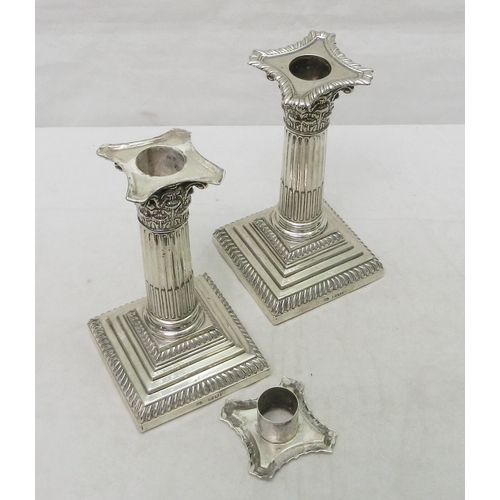 27 - A pair of silver Corinthian column candlesticks, early 20th cent.  155mm tall.  A/F