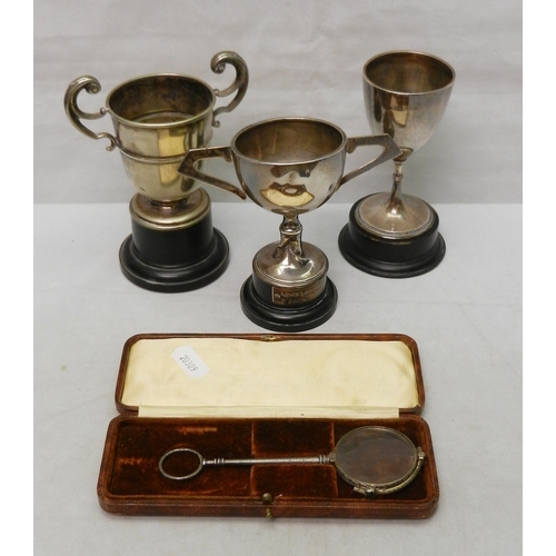 75 - A silver trophy cup; a two-handled silver trophy cup; a silver plated squat trophy cup; a cased base... 