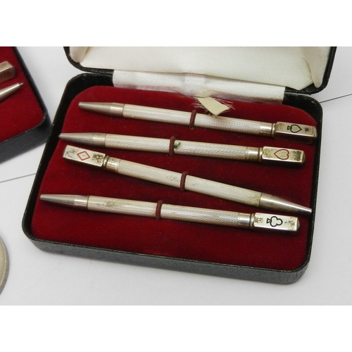 76 - Two cased sets of four bridge marker pencils, white metal marked Sterling; three commemorative coins... 