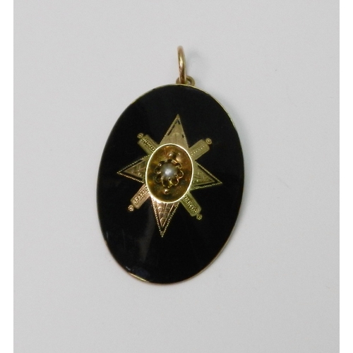 60 - An oval mourning pendant, black enamel on yellow metal having a central seed pearl in a claw setting... 