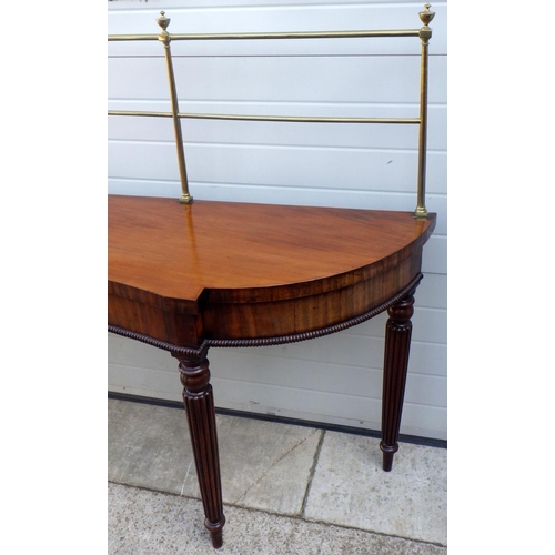 831 - A 19th cen mahogany serving table with brass gallery on reeded legs, some restoration, 199cm wide