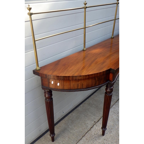 831 - A 19th cen mahogany serving table with brass gallery on reeded legs, some restoration, 199cm wide