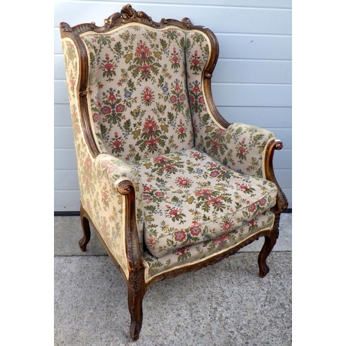 837 - A floral upholstered gilt decorated wingback chair, early 20th cen